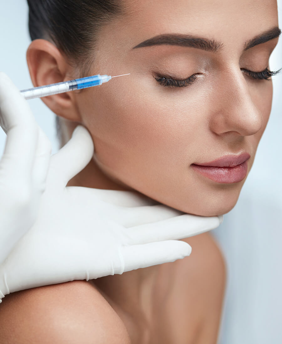 Woman getting an injection in her crows feet