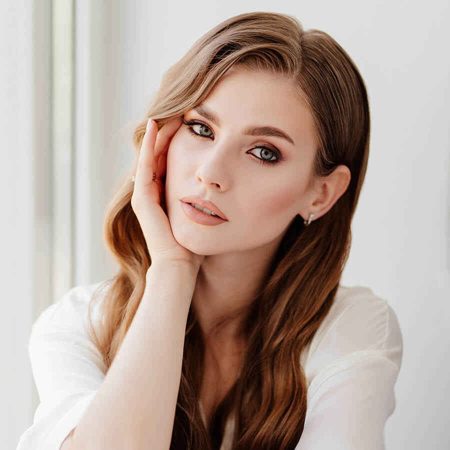 Beautiful woman with her hand on her chin