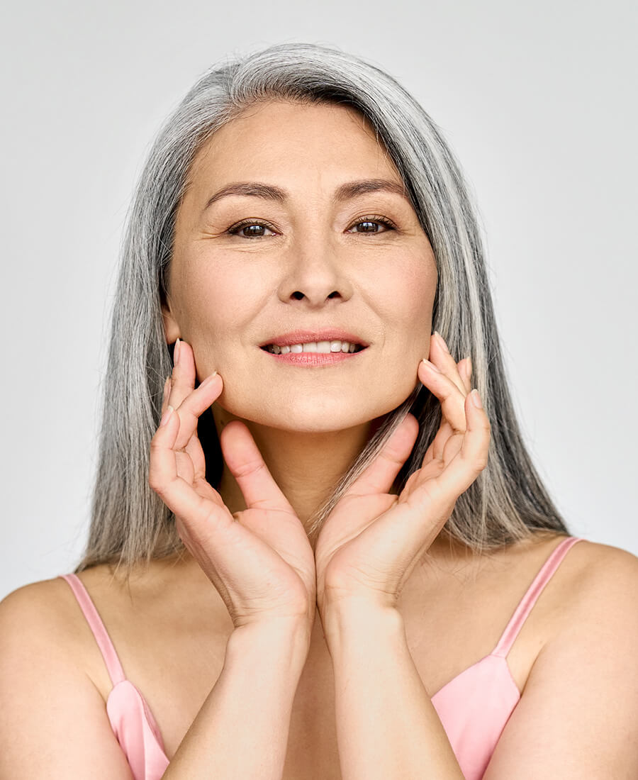 Mature woman touching her face