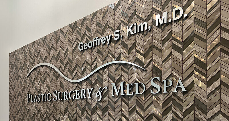 Wall sign of Geoffrey Kim, MD Plastic Surgery and Med Spa