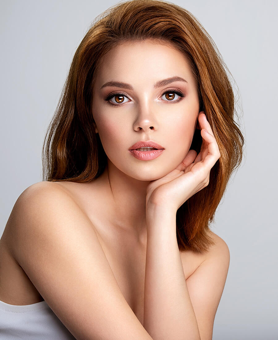 Beautiful young woman with her hand on her chin